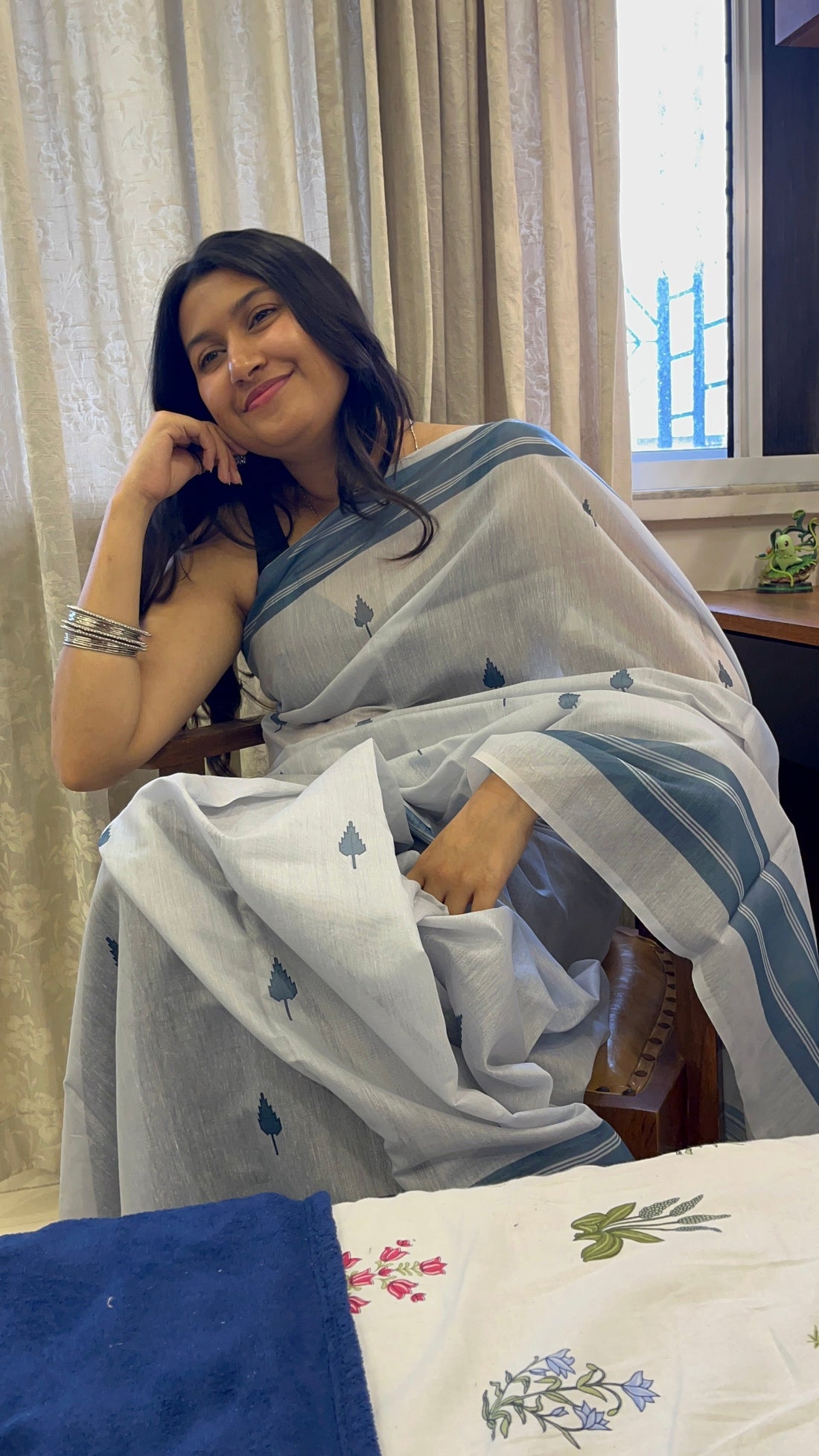 Woman adjusting saree length based on height