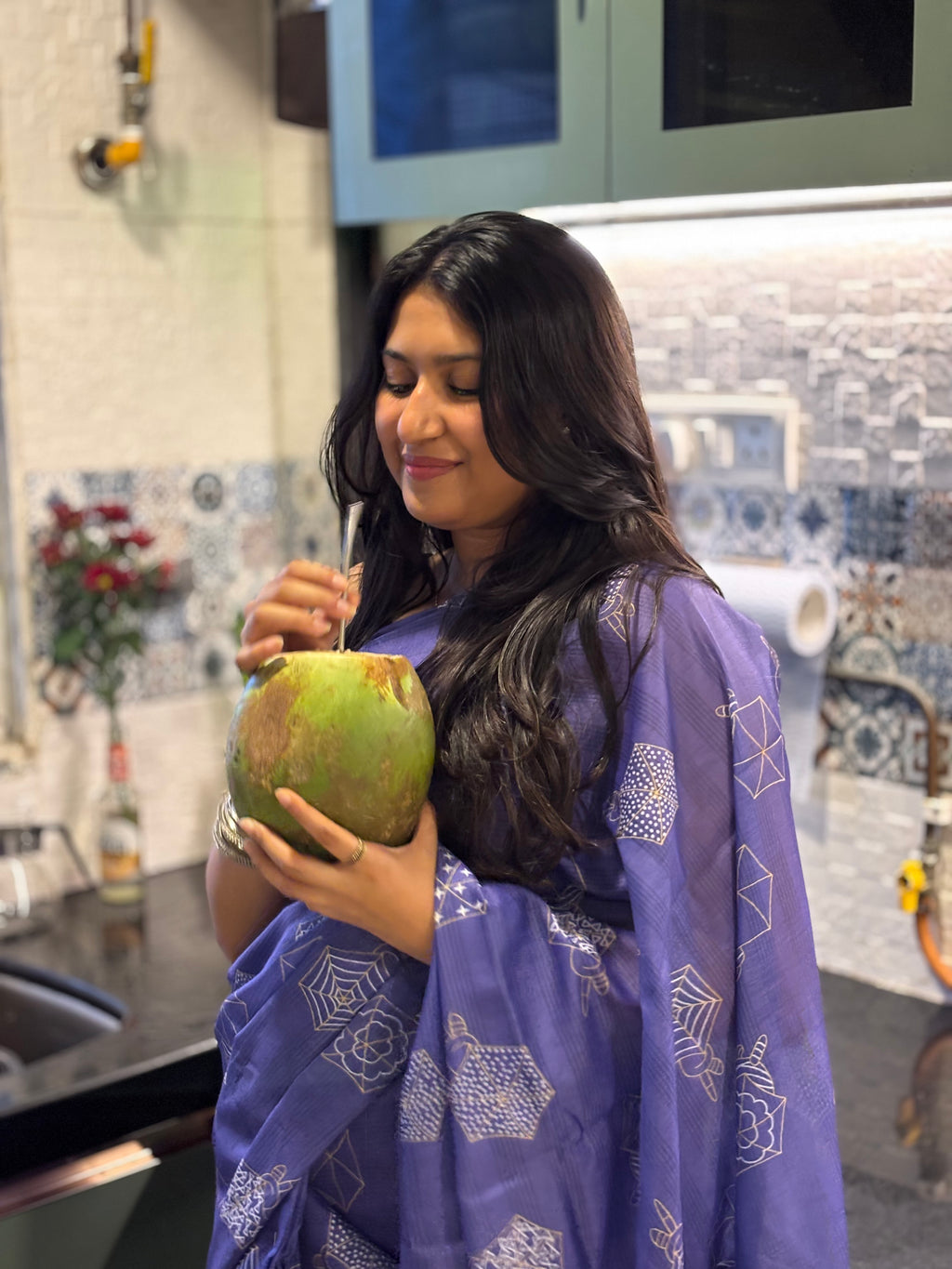 WOMAN drinking coconut water wearing pure 100% cotton saree. Purple colour cotton saree.