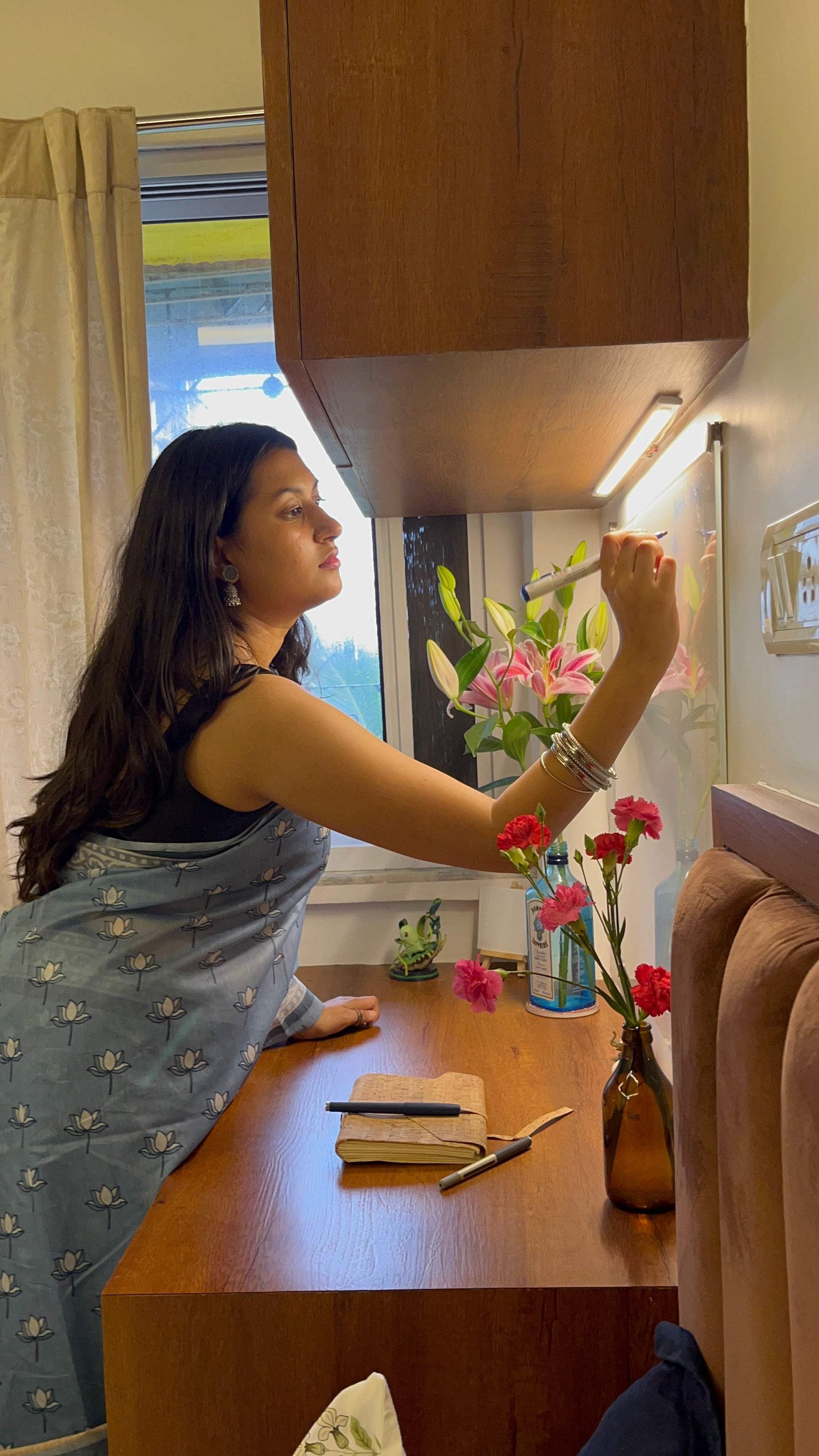 Working women wearing blue saree. blue sari. Blue cotton saree. cotton sari for women. cotton saree lotus print.